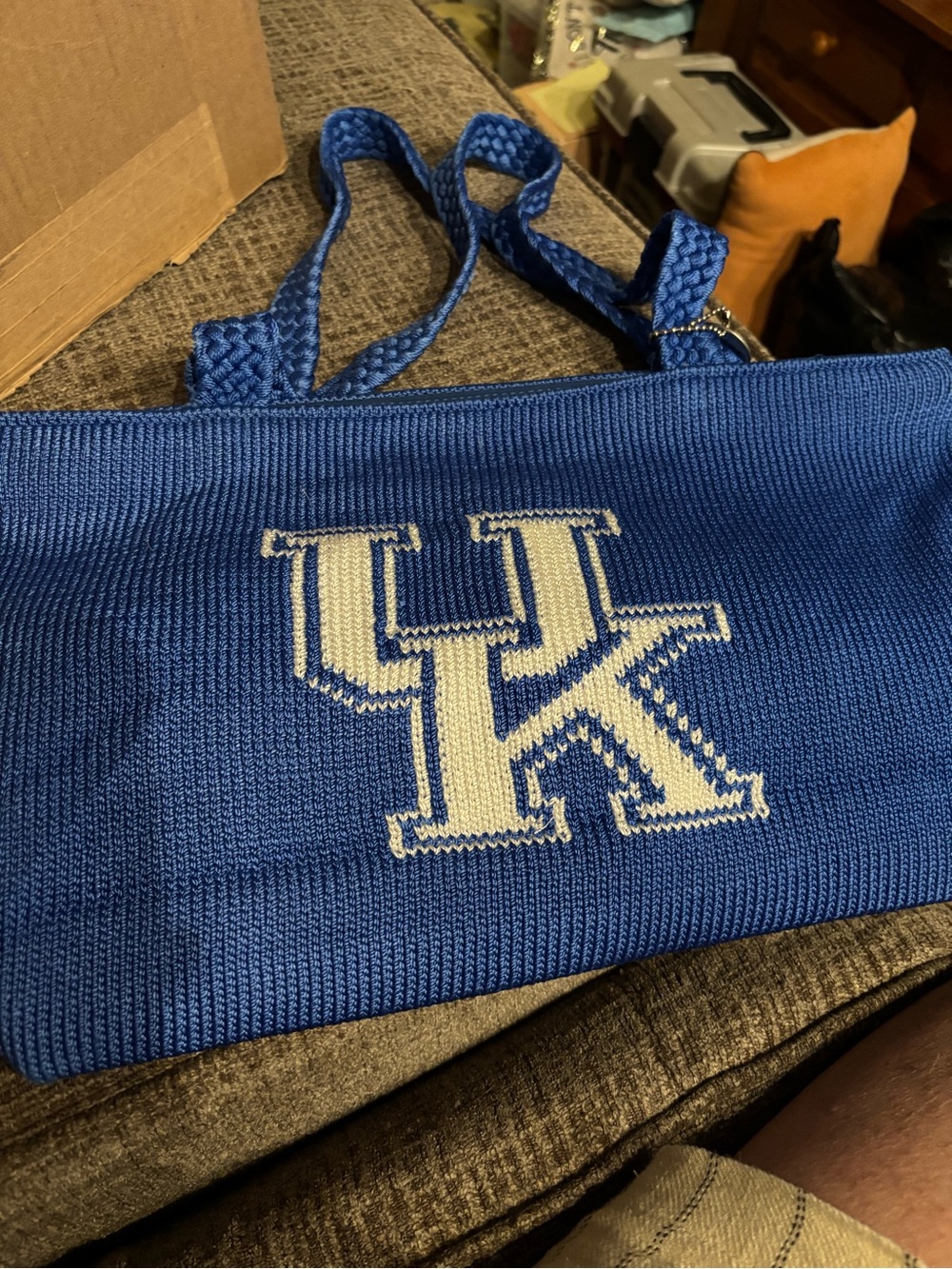 The Sak blue knit messenger bag with white UK logo